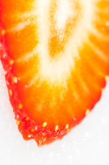 Thin sliced strawberry closeup on white background
