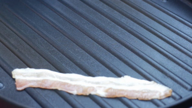 Bacon grilled on teflon pan, Stock Video