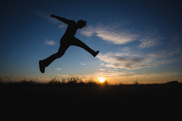 man jumping in sunset