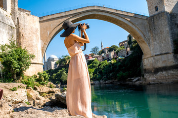 Woman photographing city view in Mostar