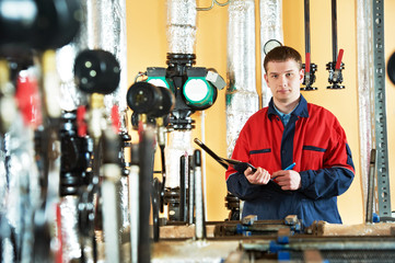 heating engineer repairman in boiler room