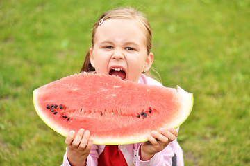 Little girl eating watermelon
