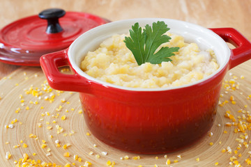 Corn perridge in red bowl