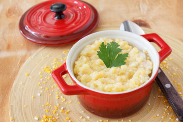 Corn perridge in red bowl