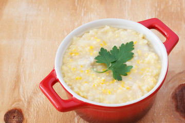 Brazilian corn soup canjiquinha in red bowl