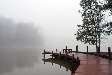 Thick Blanket Of Fog Covers Lake And Wooden Dock