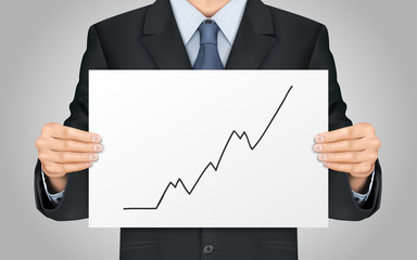 businessman holding growing business graph