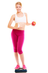 Woman holding vitamins and apple. Health care.