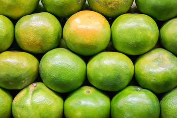 Green orange fruit on stand