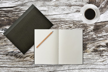 Grid notebook with wood pencil and coffee on table (Top View)