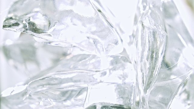 Cola with ice. Pouring Cola with Ice and bubbles from the bottle in a glass. Slow motion 240 fps. Close up food and beverage background. Stock full HD video footage 1920x1080p.