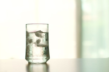 glass of Cool fresh drink with ice cube on the  table