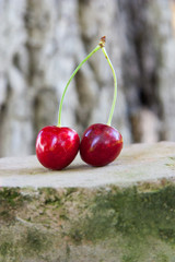 Fresh red cherry on stone