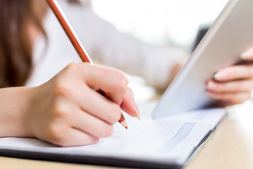 Asian beautiful female student study in classroom with tablet