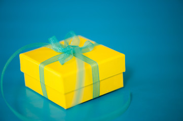 Yellow Gift Box on a Blue Background