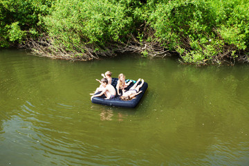 Fototapeta na wymiar Children floating on the river