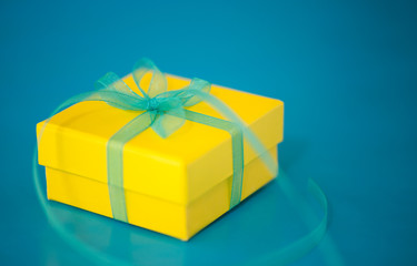 Yellow Gift Box on a Blue Background