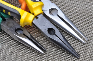 Pliers tools for electrician on metal surface
