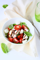 fresh salad in white bowl, italian caprese salads