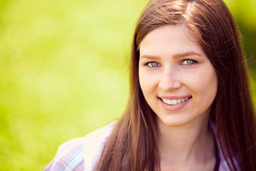 Fototapeta premium Attractive young woman enjoying her time outside in park with su
