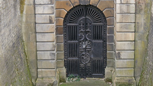 The big black gate on basement in the cemetery. It is the basement on the chapel found in the cemetery.