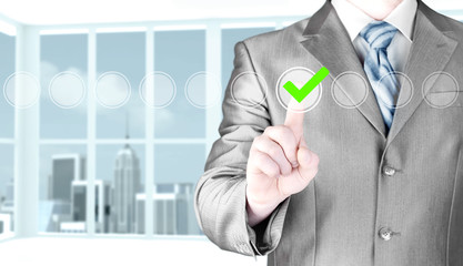 business man touching, pressing modern button with green ticking