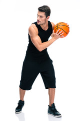 Handsome man im sports wear playing in basketball