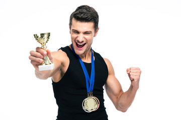 Cheerful sports man holding winner cup