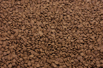 Dry pet food (dog or cat) brown background