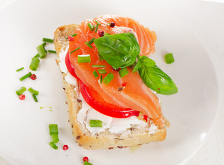 Sandwich with cereals bread and salmon on  a plate.