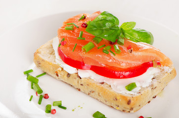 Sandwich with cereals bread and salmon on   plate.