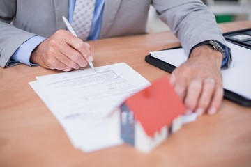 Businessman writing on a paper