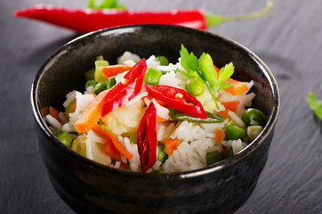 Rice and  vegetables on  black table.