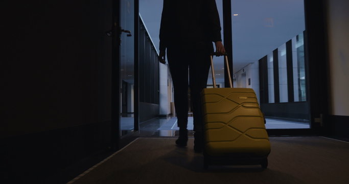 Woman with travel bag walking to her hotel room