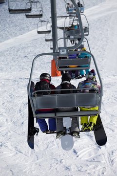 Snowboarders on chair-lift