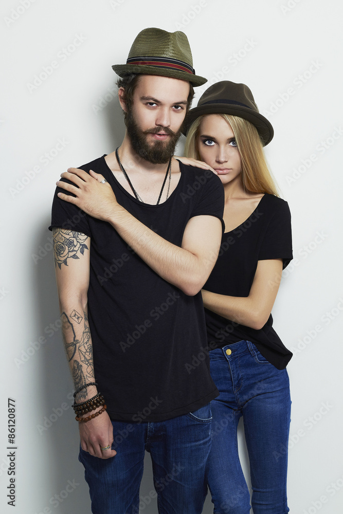 Wall mural fashion beautiful couple in hat together. hipster boy and girl.tattoo