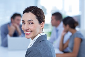Fototapeta premium Smiling businesswoman looking at camera