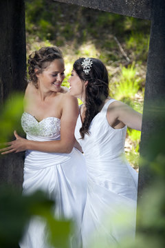 romantic picture of two brides in nature surroundings