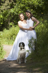just married lesbian pair with dog in forest