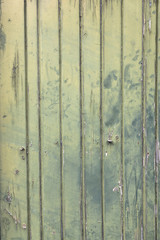 faded green planks of old wooden door