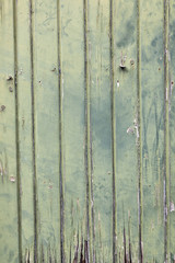 faded green planks of old wooden door