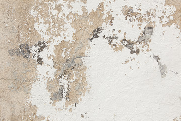 pattern of broken stucco and paint on wall