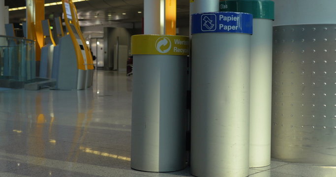 Woman throwing garbage into paper litterbin