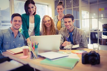 Portrait of smiling casual colleagues using computer
