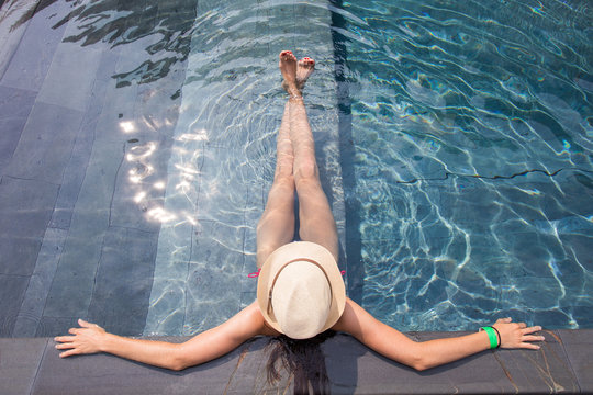 View from the top of a girl relaxing in the swimming pool