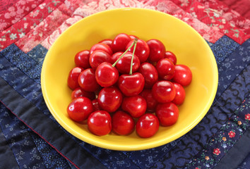 Ripe juicy berries cherries in a yellow plate