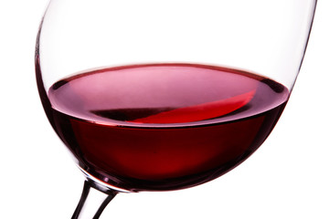 Red wine in the glass . closeup macro shot isolated on white. 