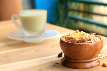 Oat flakes and milk on wooden background.