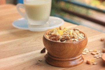 Oat flakes and milk on wooden background.