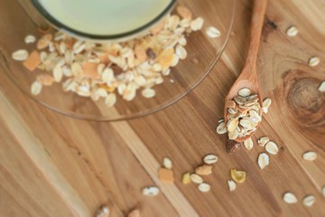 Oat flakes and milk on wooden background.